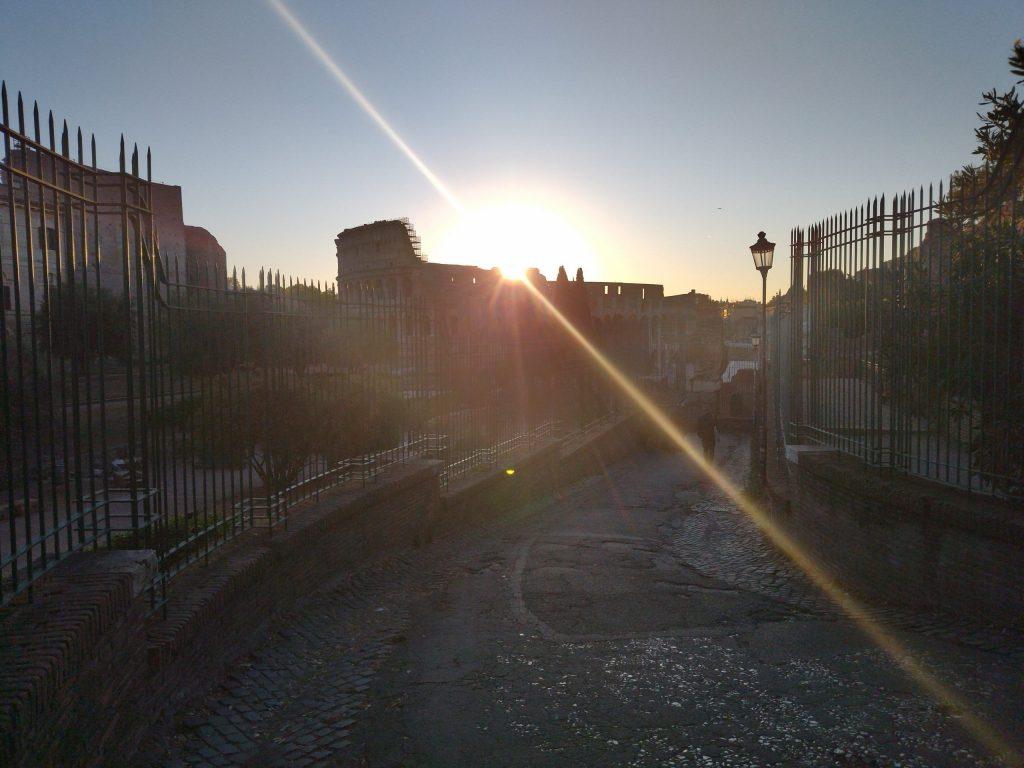 Roma, sun rising over the Colosseum